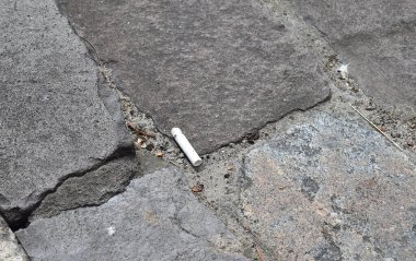 A cigarette butt on the pavement. The concept of unconsciousness.