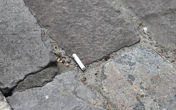 Cigarette Butt Pavement Concept Unconsciousness — стокове фото
