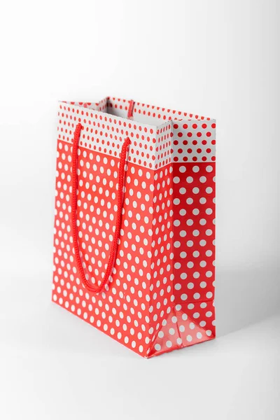 stock image Bright red polka dot gift bag isolated on white background.