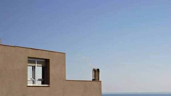 profile of minimalist house against blue sky