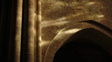 light reflections on stone wall and arch