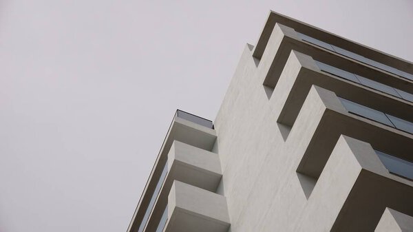 Low angle of white facade of residential building