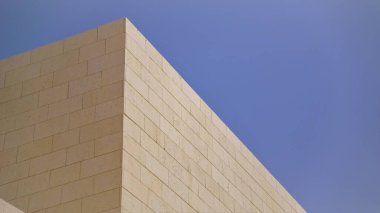 angled corner of stone walls against the sky clipart