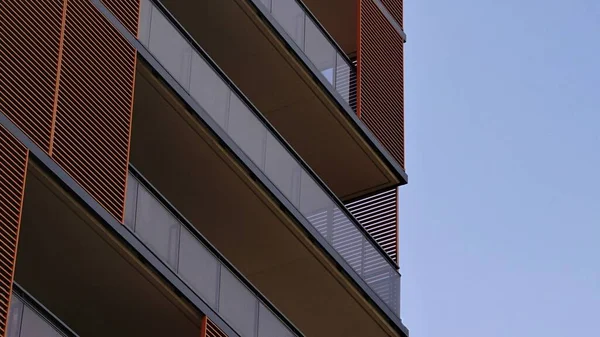 ガラスバルコニーとパラソル付きのモダンな建物のファサード — ストック写真