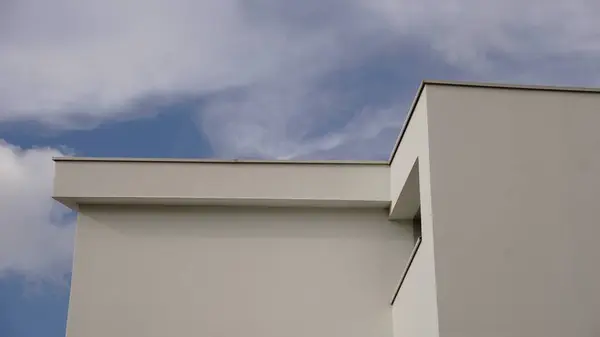 minimalist modern house facade against blue sky