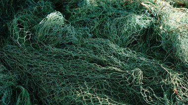 Gün ışığında birbirine dolanmış yeşil balık ağı yığını