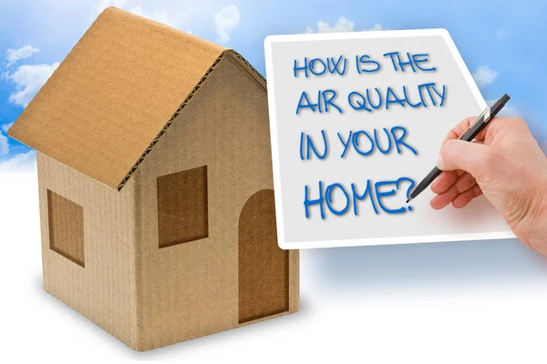 HOW IS THE AIR QUALITY IN YOUR HOME? - concept with a cardboard house