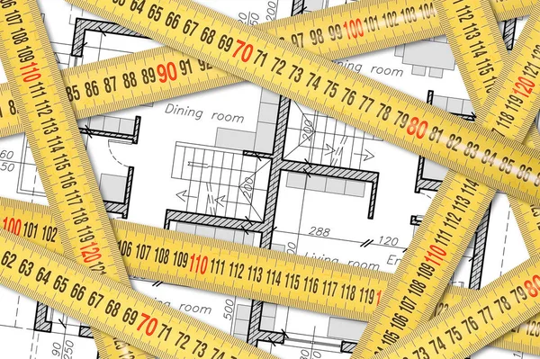 Measurement and survey of a residential building - concept with yellow metal ruler