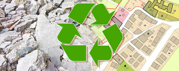Recovery and recycling of concrete and brick rubble debris on construction site after a demolition of building - concept with a city map and buildings