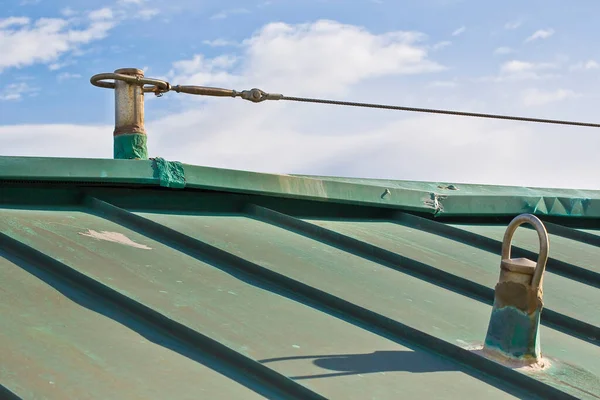 Horizontal lifeline fall protection system with inox stainless steel cable on copper roof used to prevent the danger of falling