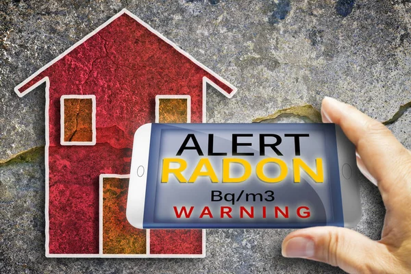 Portable information device for monitoring radioactive gas radon - radon testing concept image against a cracked wall.