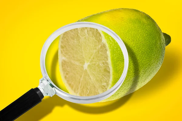 stock image Benefits of lemon - HACCP (Hazard Analysis and Critical Control Points) - Food Safety and Quality Control in food industry - concept with lemon fruit seen through a magnifying glass