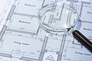 Residential building project - concept macro photography of print on paper and magnifying glass clipart