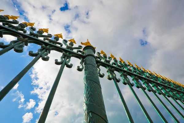 Stock image Detail of an old cast iron gate with floral decoration