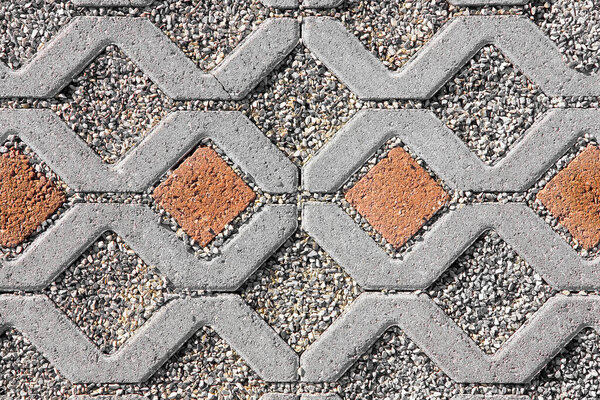 Concrete self locking tiled and draining flooring blocks assembled on a substrate of sand with gravel - type of flooring permeable to rain water as required by laws used in car parking areas