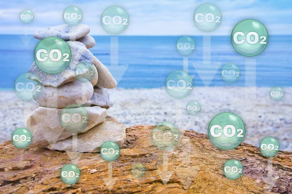 CO2 Carbon dioxide emissions are absorbed by the oceans causing warming of the seas and acidification of the waters - The ocean acts as a carbon sink - Concept with seascape and CO2 molecules
