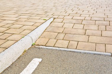 Flooring with inclined ramp in outdoors public space for overcoming an architectural barrier and accessibility for persons with disabilities