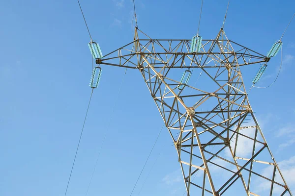 Power tower and transmission lines on blue background