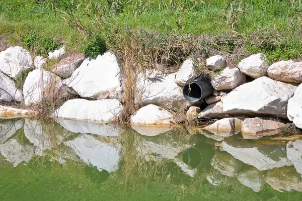 Plastic sewage pipe on a small stream