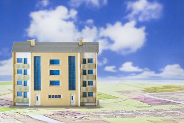 Land plot management - real estate concept with a vacant land for building construction, imaginary General Urban Plan with indications of urban destinations and condominium residential building