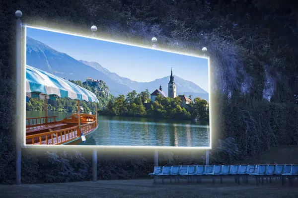 Lake Bled, the most famous lake in Slovenia with the island of the church and typical wooden boats called Pletna (Europe - Slovenia) - Outdoor cinema concept
