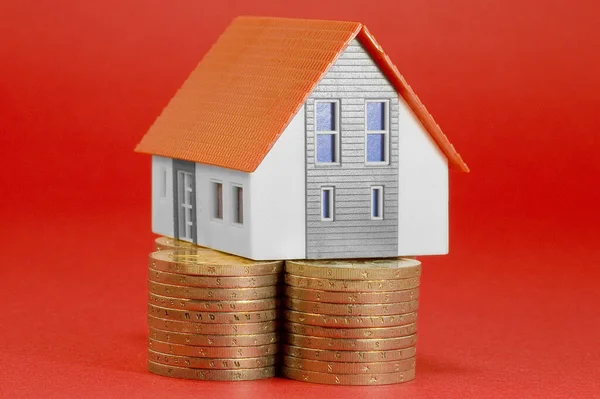 Property Tax on buildings - Property Real Estate concept with a small home model and euro coins group - Growth in property value concept