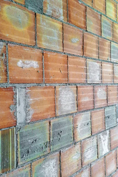 Brick wall made with hollow bricks used to make light partitions inside buildings in a italian construction site