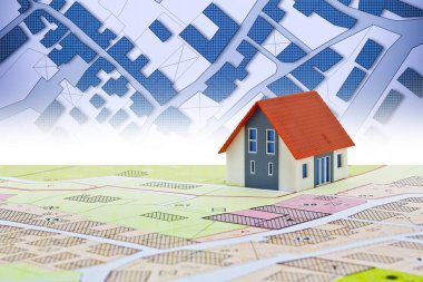 New home and free vacant land for building activity - Construction industry concept with a residential building, imaginary cadastral map, General Urban Planning and zoning regulations  