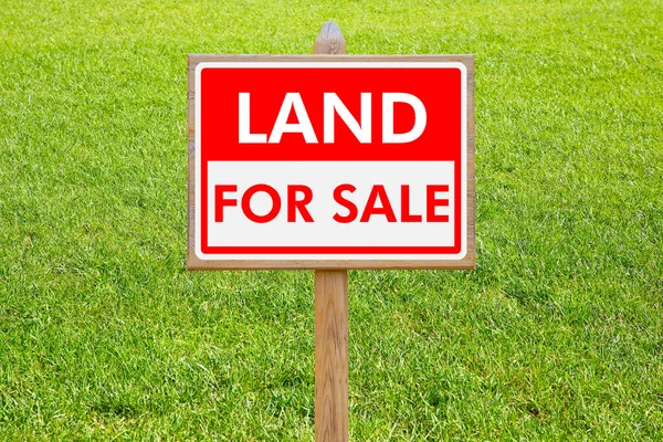 Land For Sale - Real estate concept with a vacant lot for sale available for building construction - Land plot managemen twith an advertising billboard in a rural scene