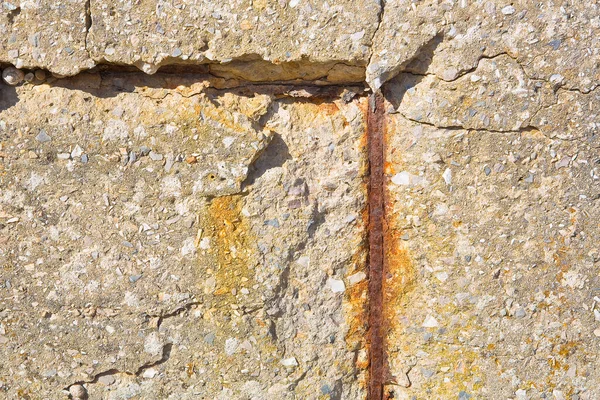Old reinforced concrete wall without concrete cover due oxidation with damaged and rusty metallic reinforcement