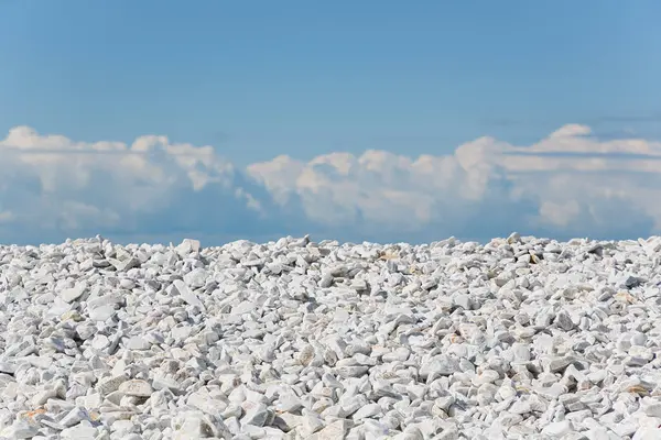 Stock image White and gray stones softly rounded against a blue sky