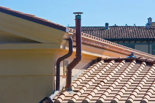 Stock image Metal chimney with copper pipe on rooftop - Exhaust pipe on the roof of the condensing boilers