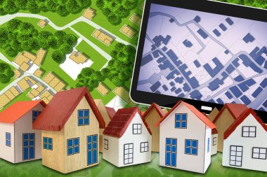 Farklı model evler grubuyla emlak kavramı, halka açık park ve yeşil alanlı hayali kadastro, kadastro haritalı dijital tablet.