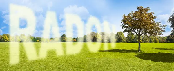 stock image The dangerous radioactive natural gas radon comes out of the ground - concept with green lawn and tree