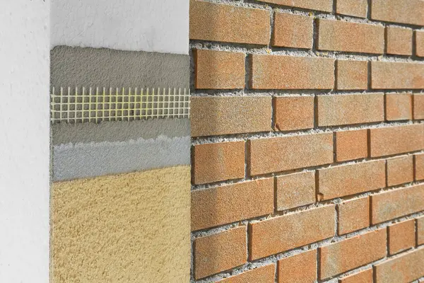 stock image Polystyrene panels for external thermal insulation of buildings - An example demonstrating application phases against a thermally insulated brick wall - Enhanced energy efficiency and performance,