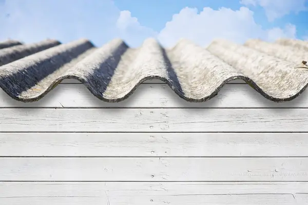 stock image Old aged roof made of corrugated asbestos panels - dangerous materials in buildings and construction industry 