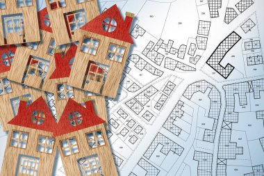 HOMEOWNER ASSOCIATION CONCEPT with group of colored house models, imaginary General Urban Plan and cadastral map with copy space clipart