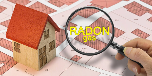 RADON GAS TESTING - Concept with magnifying glass and home model