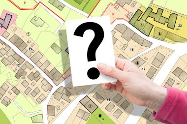 Imaginary General Urban Plan concept - zoning regulations with zoning districts, urban destinations, land use, buildable areas and land plot - concept with hand holding a card with question mark