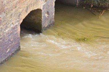 Tehlikeli, tedavi edilmemiş, zehirli su şehir kanalizasyonundan nehre akıyor.
