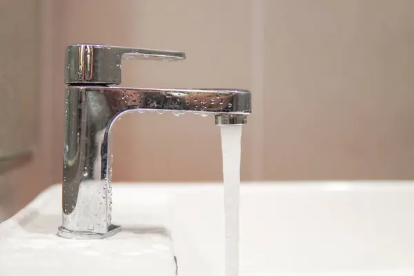 Water tap, faucet. Flow water in bathroom with sink