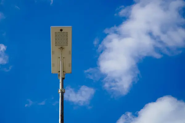 Public street lighting pole with LED lights with cloud and blue sky