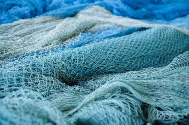 Beyaz şamandıralı mavi balık ağı yığını. Balıkçı ağı ve yüzen balıklar. Balık ağları ve ipler. Balık yakalamak için araç