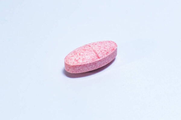 one pill on white background