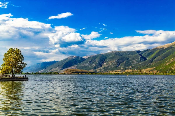 Landscape view of lake Pamvotis and the waterfront of the city of Ioannina, in Epirus, Greece, on a sunny summer day.