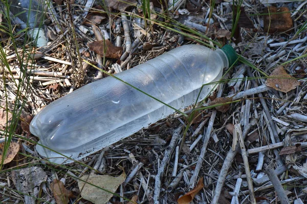 Plastic bottle with water inside on the ground