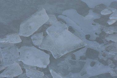 Kışın donmuş bir gölün üzerindeki donuk desen, fotoğrafın yakın çekimi.