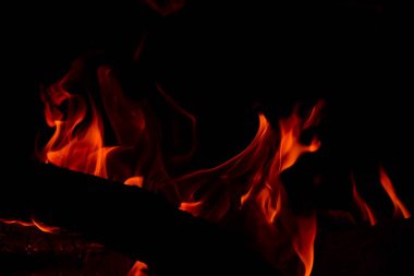 Fire flames on a black background. Burning firewood in the fireplace, close-up clipart