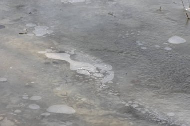 Buz içinde hava kabarcıkları olan donmuş göl yüzeyi