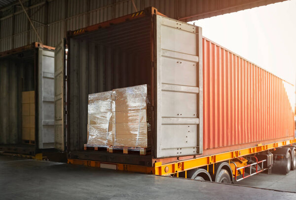Packaging Boxes Wrapped Plastic on Pallets Loading into Cargo Container. Shipping Trucks Loading Dock Warehouse. Shipment Boxes. Distribution Supplies Warehouse. Freight Truck Transport Logistics